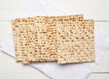 Stack of baked square matzo on a white wooden background Royalty Free Stock Photo
