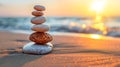 A stack of balanced stones on the ocean beach at sunset. Meditation and spa concept. Royalty Free Stock Photo