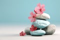 Stack of balanced zen stones, gray and white pebbles pyramid with pink cherry flowers Royalty Free Stock Photo