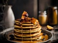 A stack of pancakes drizzled with caramel