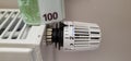 A stack of banknotes on the batteries of a central heating radiator Royalty Free Stock Photo