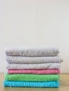 Stack of bath towels on light wooden background closeup.Pile of rainbow colored towels.Top view. Royalty Free Stock Photo