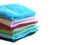 Stack of bath towels on light wooden background closeup.Pile of rainbow colored towels.Top view. Royalty Free Stock Photo