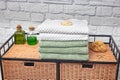 stack of bath towels on a wicker nightstand. Rattan furniture and towels in the bathroom