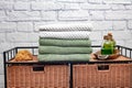 stack of bath towels on a wicker nightstand. Rattan furniture and towels in the bathroom