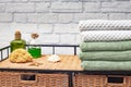 stack of bath towels on a wicker nightstand. Rattan furniture and towels in the bathroom