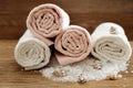 Stack of bath towels on wooden table. White and pink terry towels from cotton. Spa concept Royalty Free Stock Photo