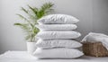 Stack of beddings on white background, white pillow against white wall