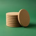 A stack of beige cork coasters is set against a green background. The coasters are Royalty Free Stock Photo