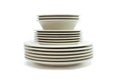 Stack of beige dinner plates, soup plates and sauc