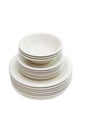 Stack beige dinner plates, soup plates and saucers