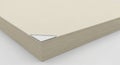 A stack of beige paper sheets, neatly aligned, forms a rectangular block. The sheets Royalty Free Stock Photo