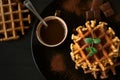 Stack Belgian waffles iced cocoa with chocolate sauce decorated mint leaves o