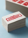 Stack of Betting Slips With Red Warning Stamp Indicating Overdrawn Status on a Clear Surface Royalty Free Stock Photo
