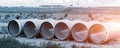 Stack of big frp composite fiberglass plastic sewage pipes at warehouse construction site near Leipzig Halle airport