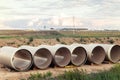 Stack of big frp composite fiberglass plastic sewage pipes at warehouse construction site near Leipzig Halle airport Royalty Free Stock Photo