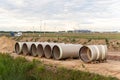 Stack of big frp composite fiberglass plastic sewage pipes at warehouse construction site near Leipzig Halle airport Royalty Free Stock Photo