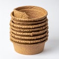 Stack of Biodegradable Brown Seedling Starter Pots on White Background Royalty Free Stock Photo