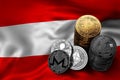 Stack of Bitcoin coins on Austrian flag. Situation of Bitcoin and other cryptocurrencies in Austria