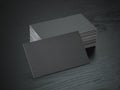 Stack of black blank business cards mockup on black wood table b