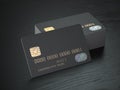 Stack of black blank credit cards mockup on black wood table background, Royalty Free Stock Photo