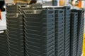 Stack of black plastic storage bins in warehouse setting Royalty Free Stock Photo