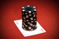 Stack of black poker chips on a red ace card Royalty Free Stock Photo