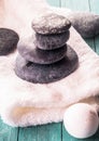 Stack of black stones on white towel Royalty Free Stock Photo