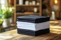 Stack of black and white folded clothes on blurred background. mockup Royalty Free Stock Photo