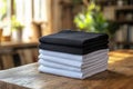 Stack of black and white folded clothes on blurred background. mockup Royalty Free Stock Photo