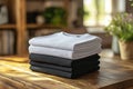 Stack of black and white folded clothes on blurred background. mockup Royalty Free Stock Photo