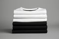 Stack of black and white folded clothes on dark background. mockup Royalty Free Stock Photo