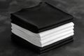 Stack of black and white folded clothes on dark background. mockup Royalty Free Stock Photo