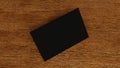 Stack of blank black business card, namecard mockup on wood table, promote company brand, 3D rendering