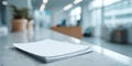 A Stack of Blank Papers on a Modern Office Desk with a Soft Focus Background Highlighting Contemporary Workspace Ambiance Royalty Free Stock Photo