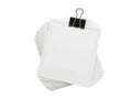 A stack of blank papers secured by a binder clip on a white background Royalty Free Stock Photo