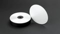 Stack of Blank Silver C Ds and One Disc Leaning Against Dark Gray Surface image photo Royalty Free Stock Photo