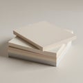 A stack of blank, square paper pads in neutral shades is arranged on a plain surface. Royalty Free Stock Photo