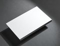 Stack of blank white business cards angled on a dark textured surface image photo Royalty Free Stock Photo