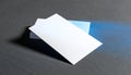 Stack of blank white business cards on a dark textured surface with blue light accent image Royalty Free Stock Photo