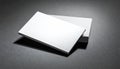 Stack of blank white business cards on a textured dark gray surface with dramatic lighting Royalty Free Stock Photo