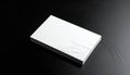 Stack of blank white business cards with white embossed wave pattern on dark surface Royalty Free Stock Photo