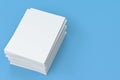 Stack of blank white closed brochure mock-up on blue background Royalty Free Stock Photo