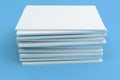 Stack of blank white closed brochure mock-up on blue background Royalty Free Stock Photo