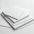 A stack of blank white paper sheets arranged on a flat surface. The sheets vary in size, Royalty Free Stock Photo