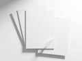 A stack of blank white paper sheets on a light surface with shadows Royalty Free Stock Photo