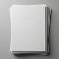A stack of blank white sheets of paper is neatly arranged on a gray surface Royalty Free Stock Photo