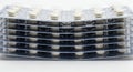 Stack of blister packs with white pills on white background Royalty Free Stock Photo