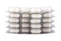 Stack of blisters with pills on white background