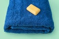 Stack of blue clean bath towels and handmade eco soap, beauty and massage spa concept Royalty Free Stock Photo